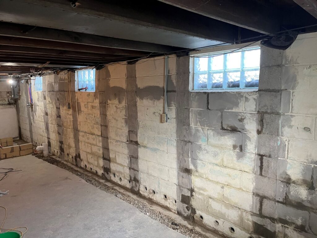 Efflorescence (white powdery deposit) on a basement wall
