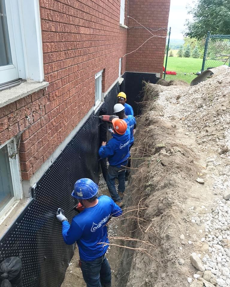 Exterior basement waterproofing Toronto project by Dryshield showing excavation and weeping tile installation.