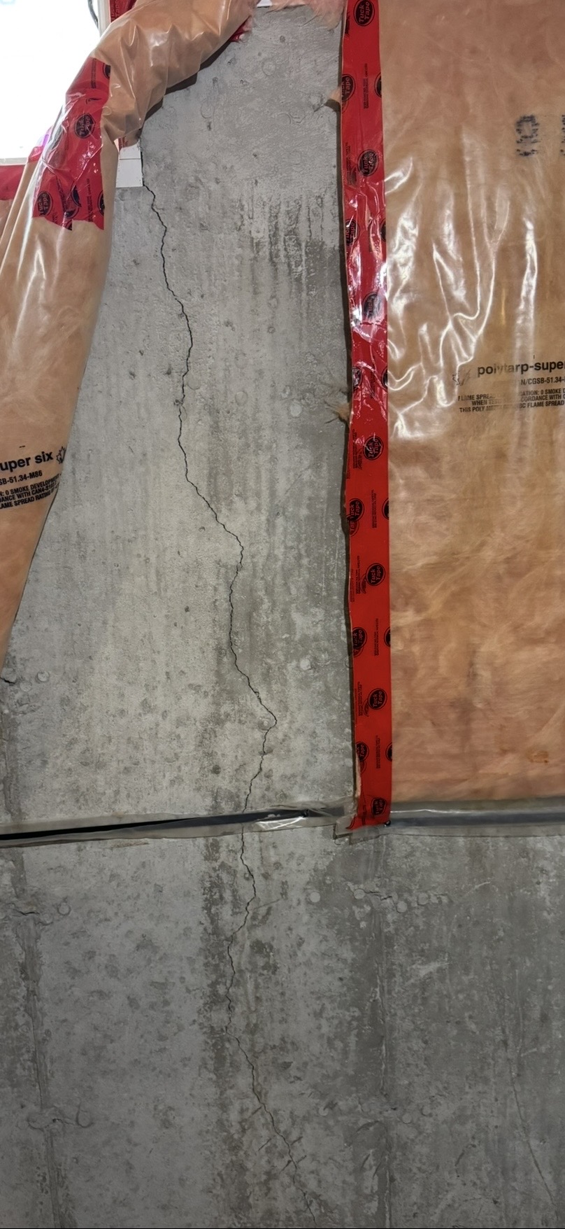 Active leak through a basement foundation wall crack photographed by Dryshield during a Toronto-area inspection