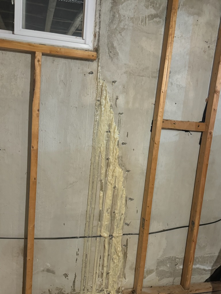 Foundation crack on a residential concrete basement wall being prepared for crack injection repair by Dryshield