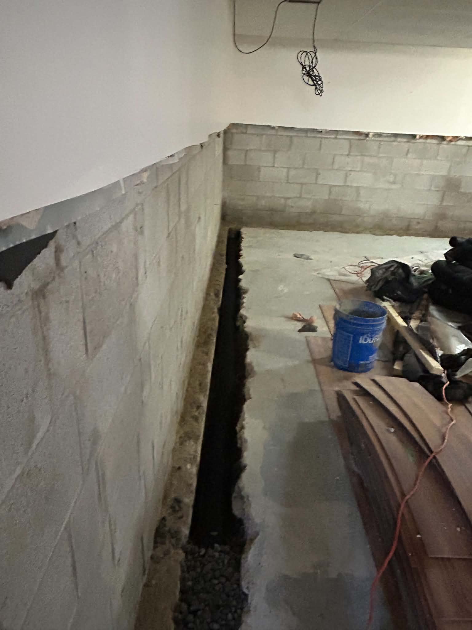 Interior basement waterproofing installation with sub-floor weeping tile system by Dryshield